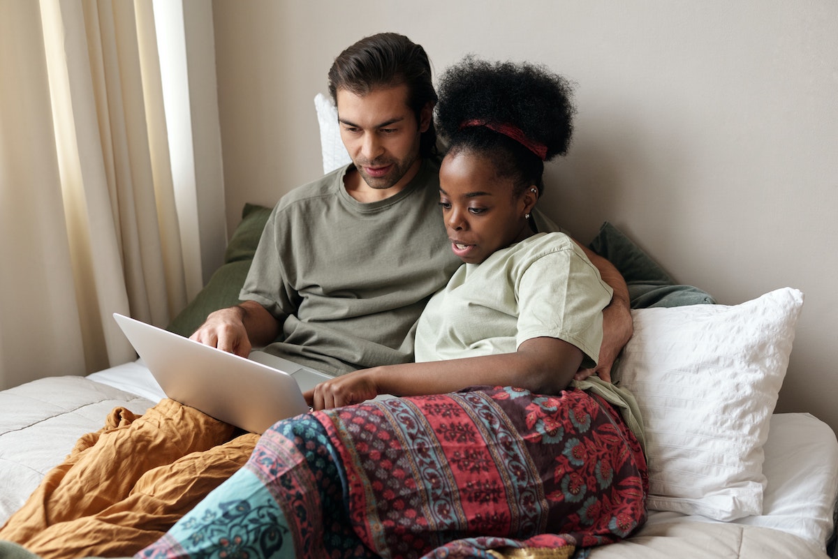 Couple on a laptop, making plans to buy a house